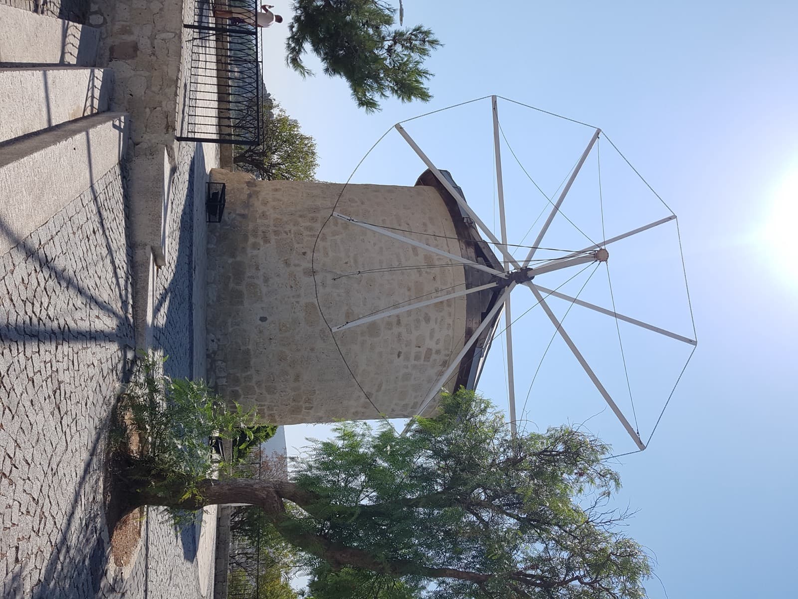 Restored stone windmill on the ridge above Alacati old town